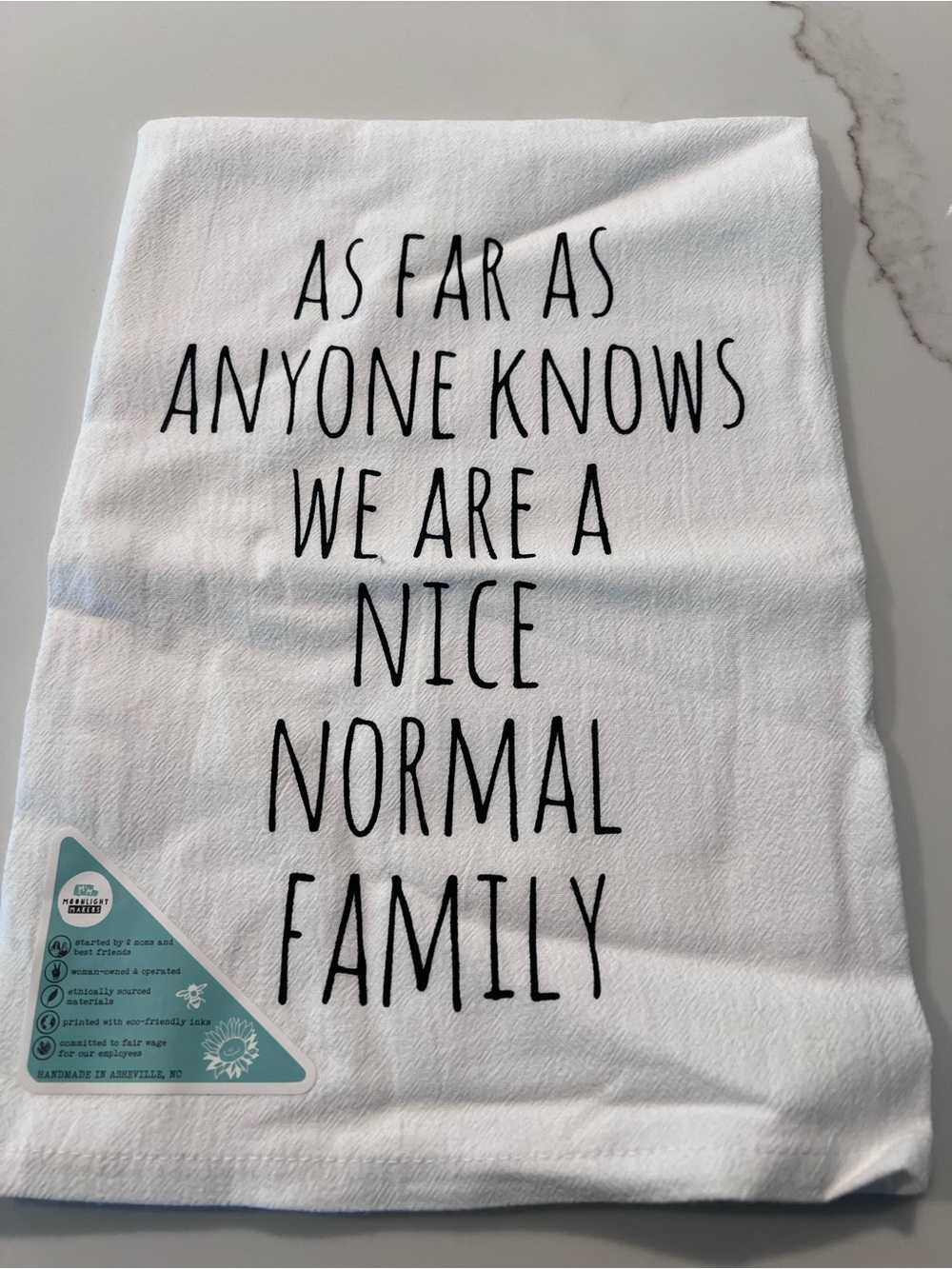 White Kitchen Towel with Black Lettering "Nice Normal Family"